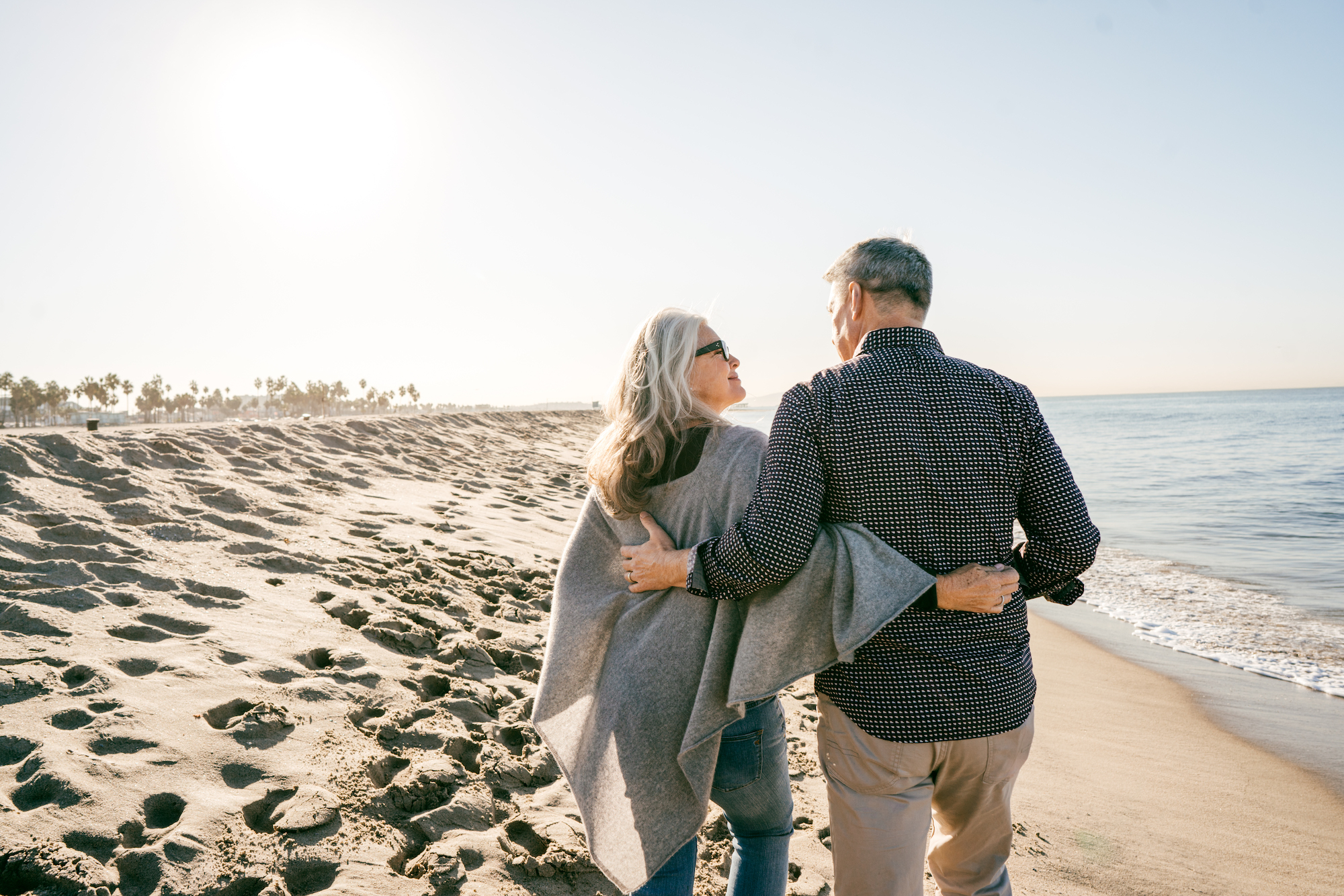 Middle-aged couple walking along the beach